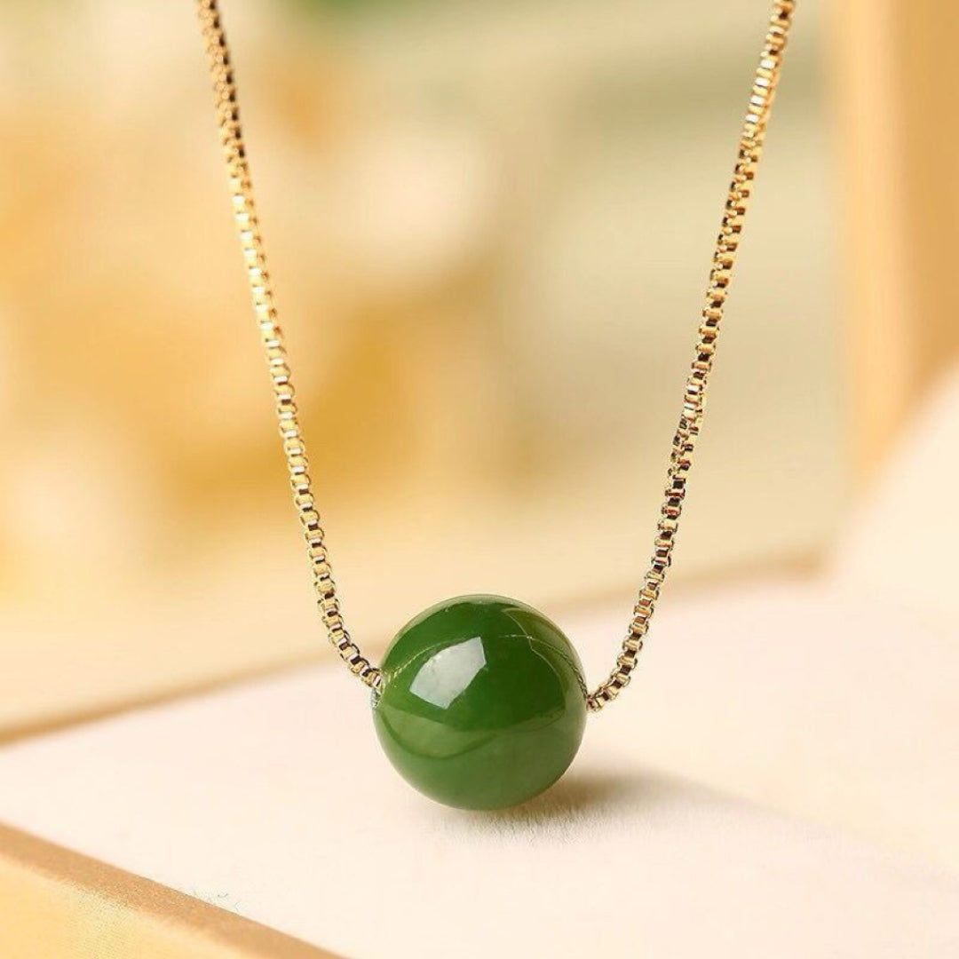 Acorn Green Jade Pendant Necklace with a delicate gold chain.