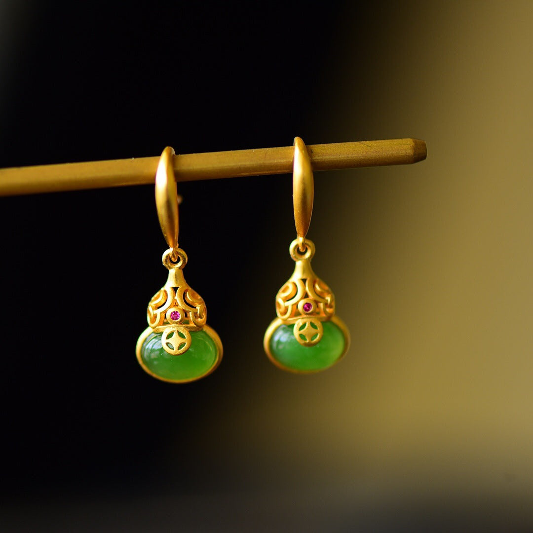 A pair of Brimful Green Jade Gourd Drop Earrings with intricate gold detailing and small ruby accents.