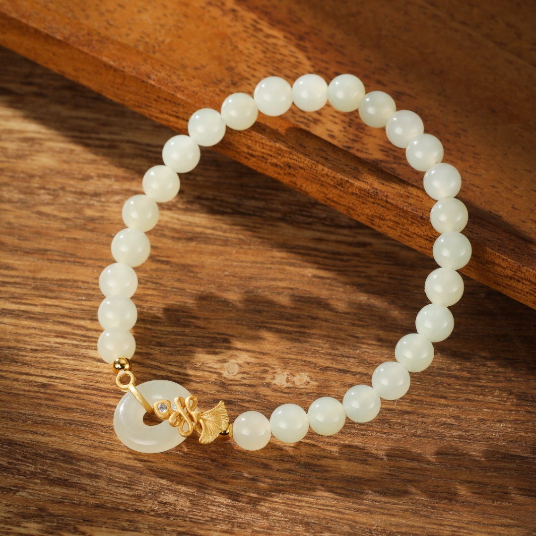 Charmed Life Hetian Jade Bi Disc Beaded Bracelet with gold plated leaf charm and a small clear stone