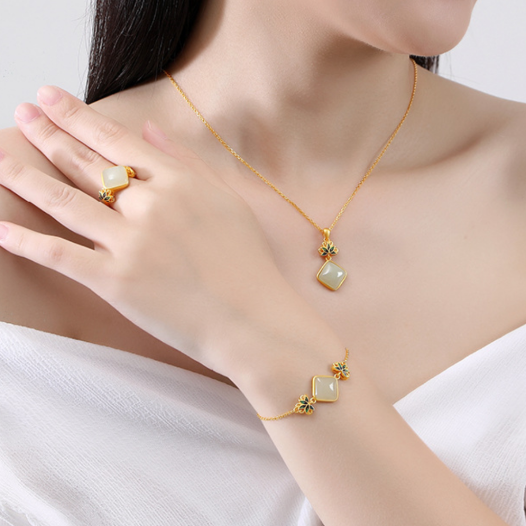 Ease Hetian Jade Lotus Pendant Necklace with matching ring and bracelet worn by a woman.