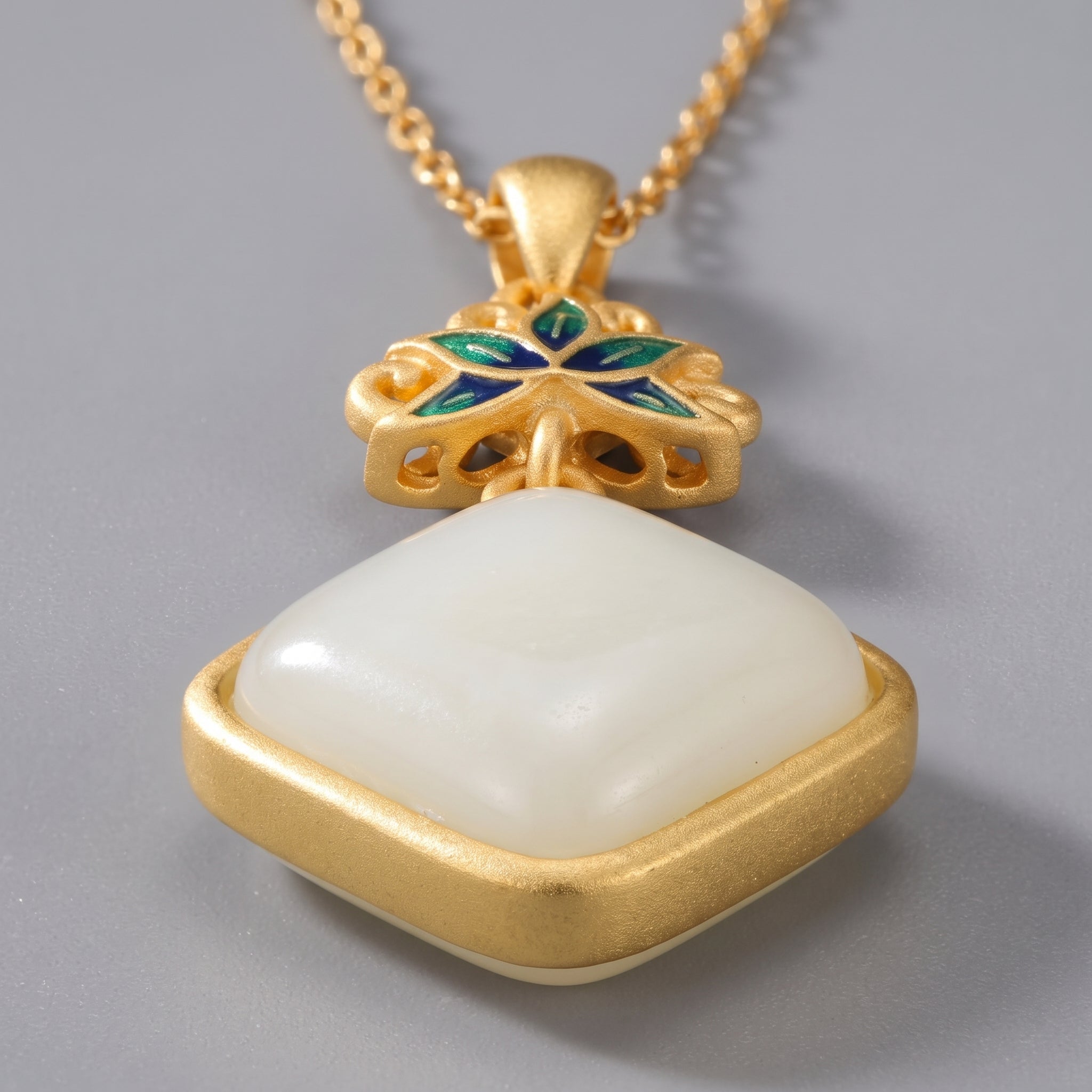 Gold necklace featuring a square Hetian jade pendant with blue and green enamel lotus flower detail