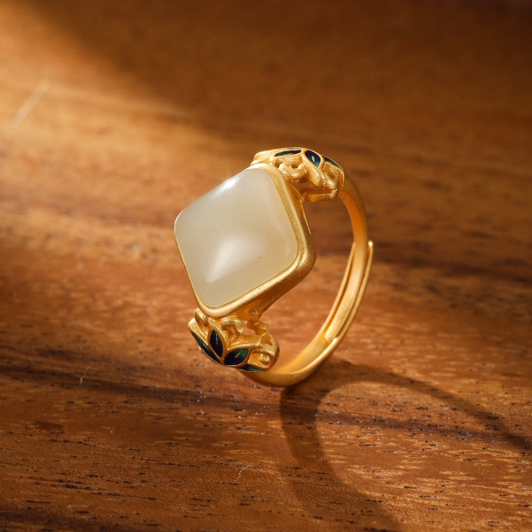 Ease Hetian Jade Lotus Ring with a square-cut white jade stone set in a gold-plated silver band with intricate lotus leaf details.