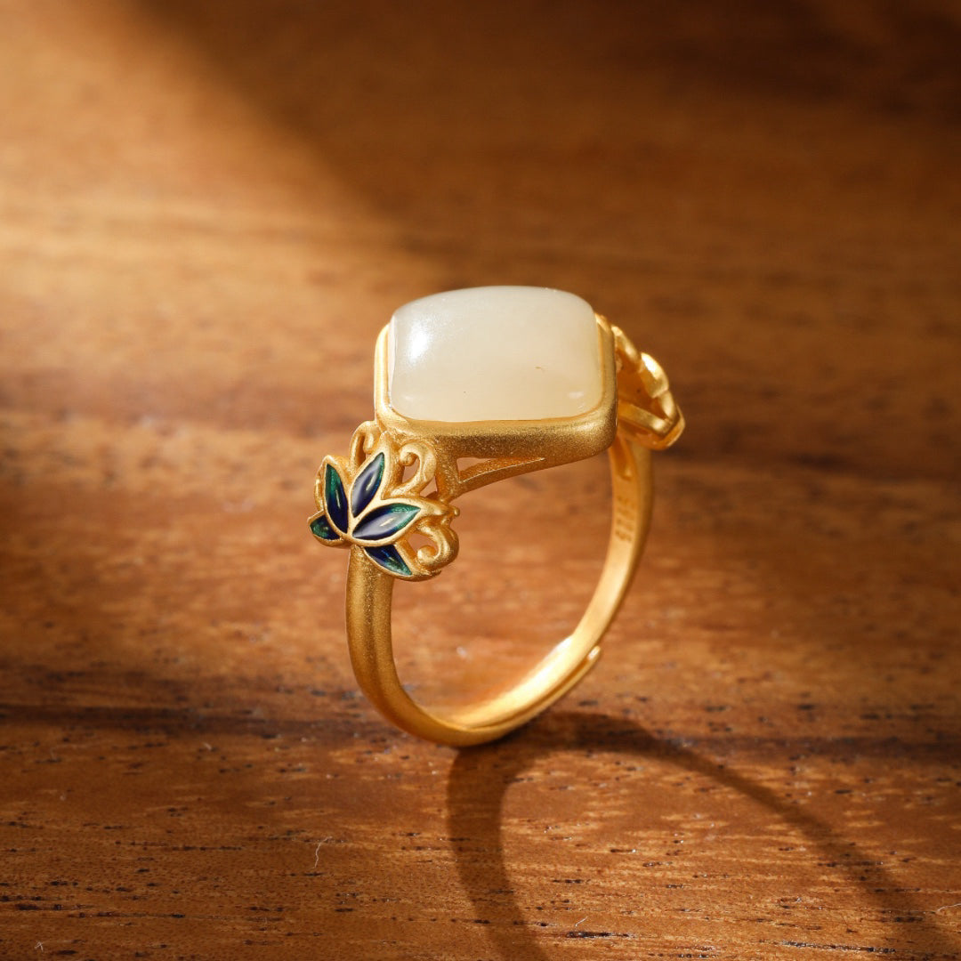 Gold-plated silver ring featuring a square, light-colored Hetian jade stone and delicate lotus leaf details in blue and green enamel.