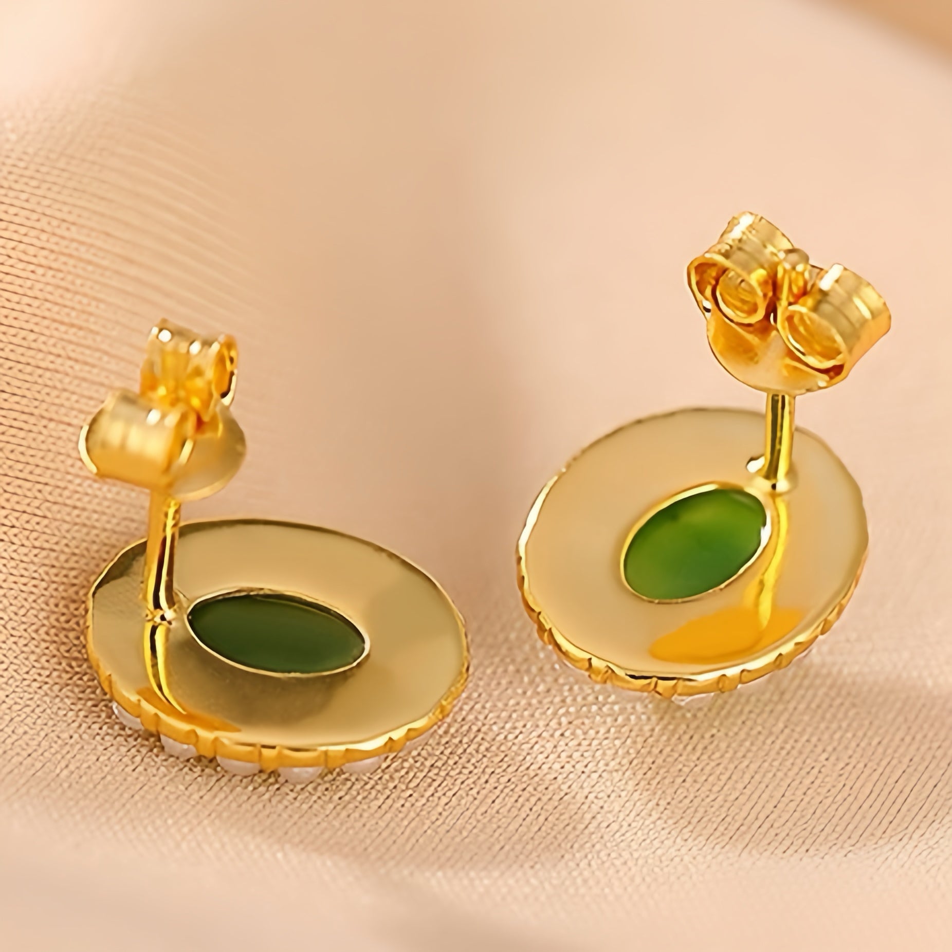 Close-up of the back of First Light Green Jade Sun Stud Earrings, showcasing the gold plating and the vibrant green jade stone.