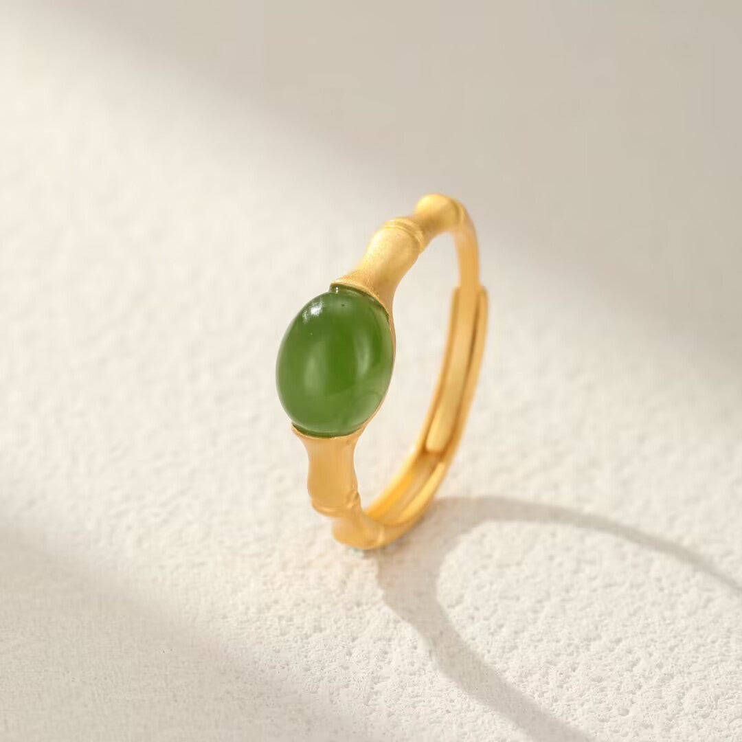 Gold plated silver ring with a green jade stone, designed to resemble bamboo stalks.