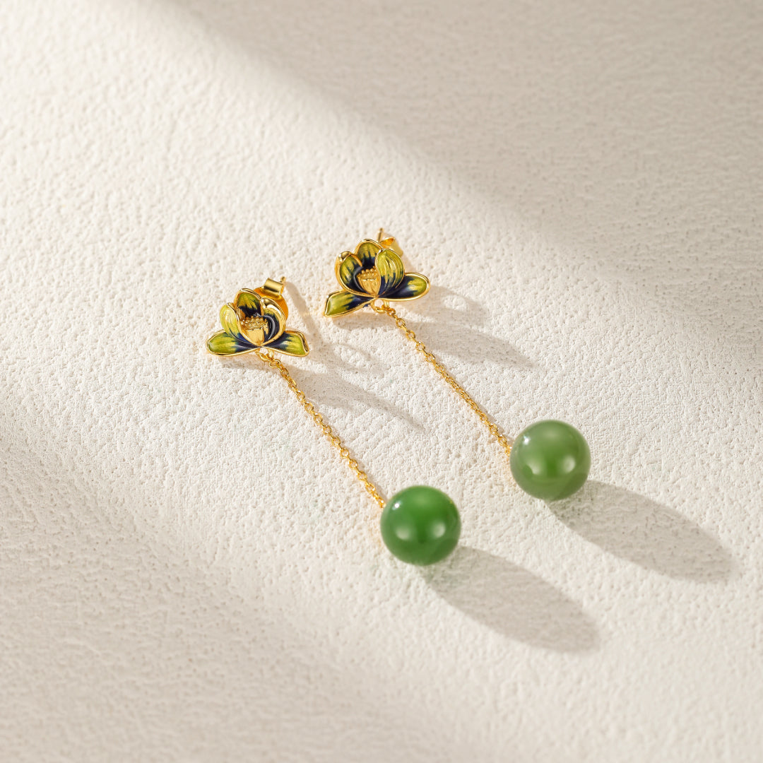 Halcyon green jade lotus drop earrings with gold-plated chains, showcasing delicate lotus flower tops and smooth jade beads.