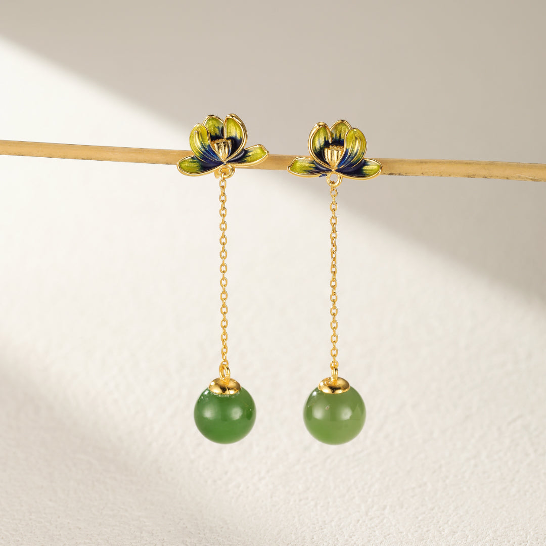 Pair of Halcyon green jade lotus drop earrings with gold plated chains