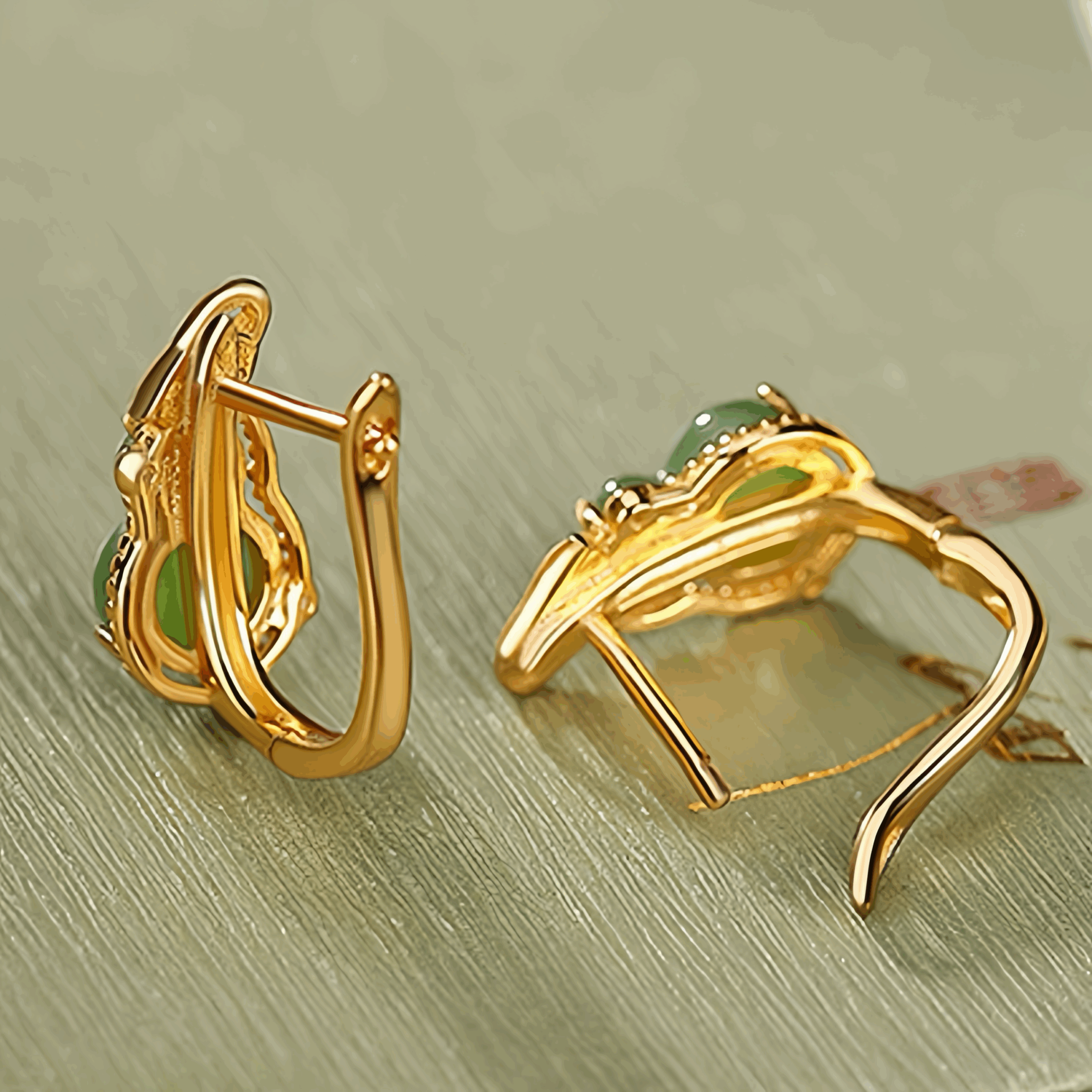 Harvest Green Jade Gourd Hoop Earrings - A pair of gold-plated hoop earrings featuring green jade gourd-shaped stones set in a delicate leaf design.