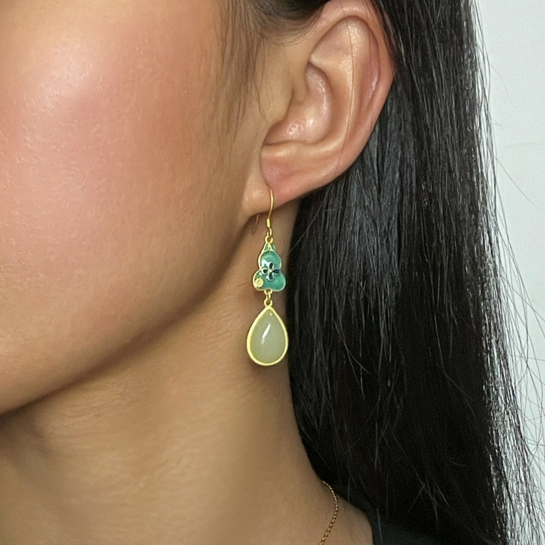 Elegant gold-plated silver earrings featuring a teal enamel gourd charm and a teardrop-shaped pale green jade stone.