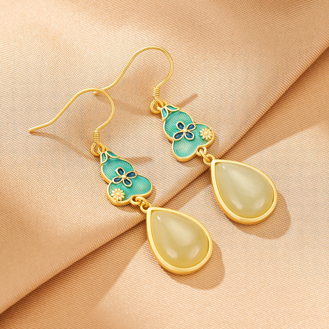 Gold plated silver earrings with turquoise enamel gourd shape and floral details, featuring teardrop-shaped jade stones.