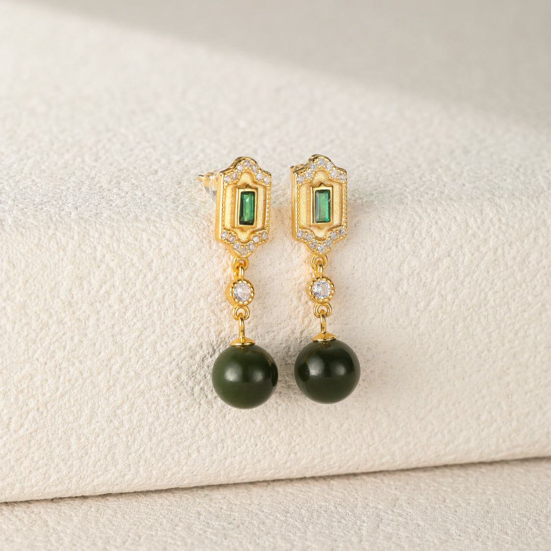 Kindred green jade and emerald drop earrings with sterling silver settings and cubic zirconia accents.