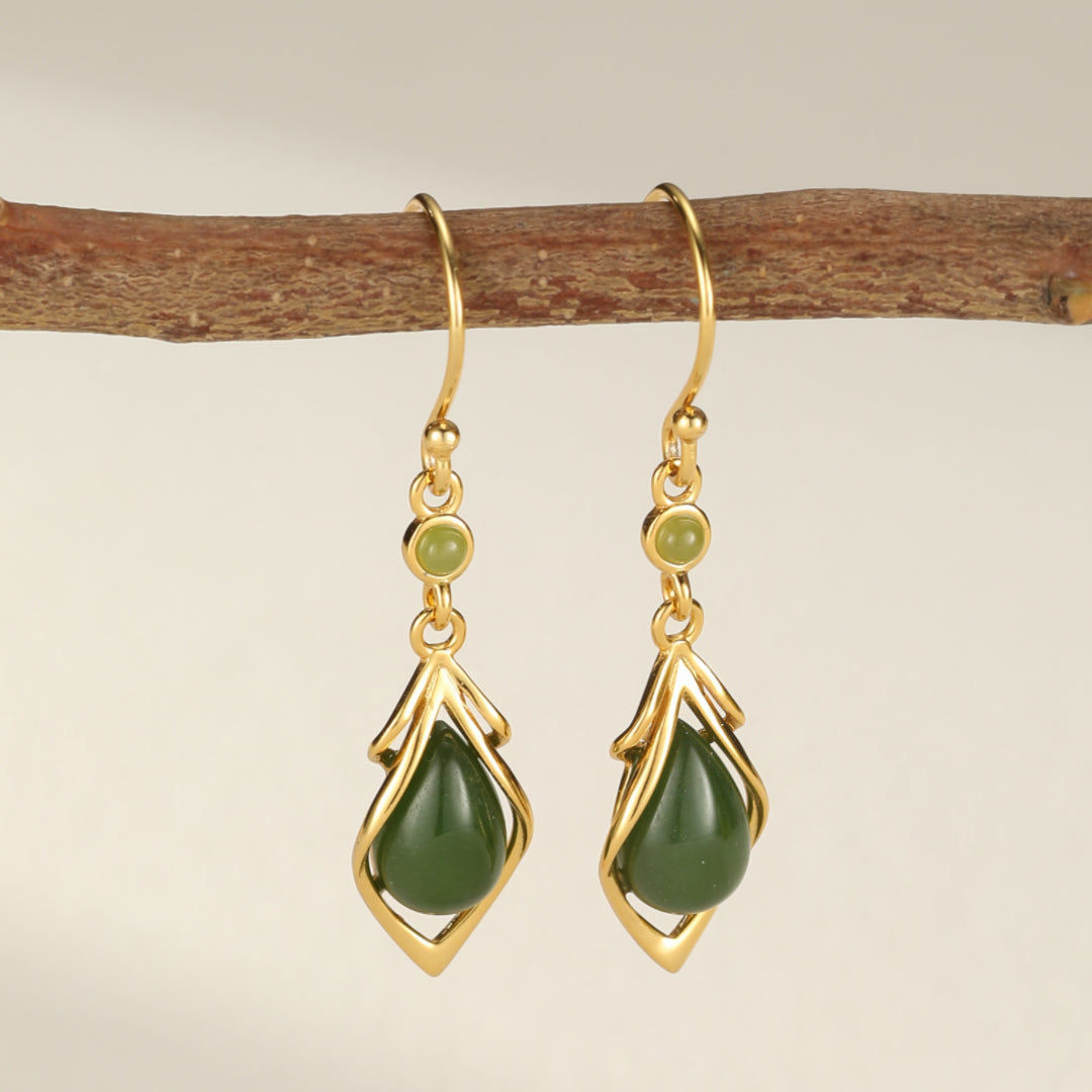 Linger Green Jade Water Drop Earrings with gold accents and green stone details hanging from a branch.