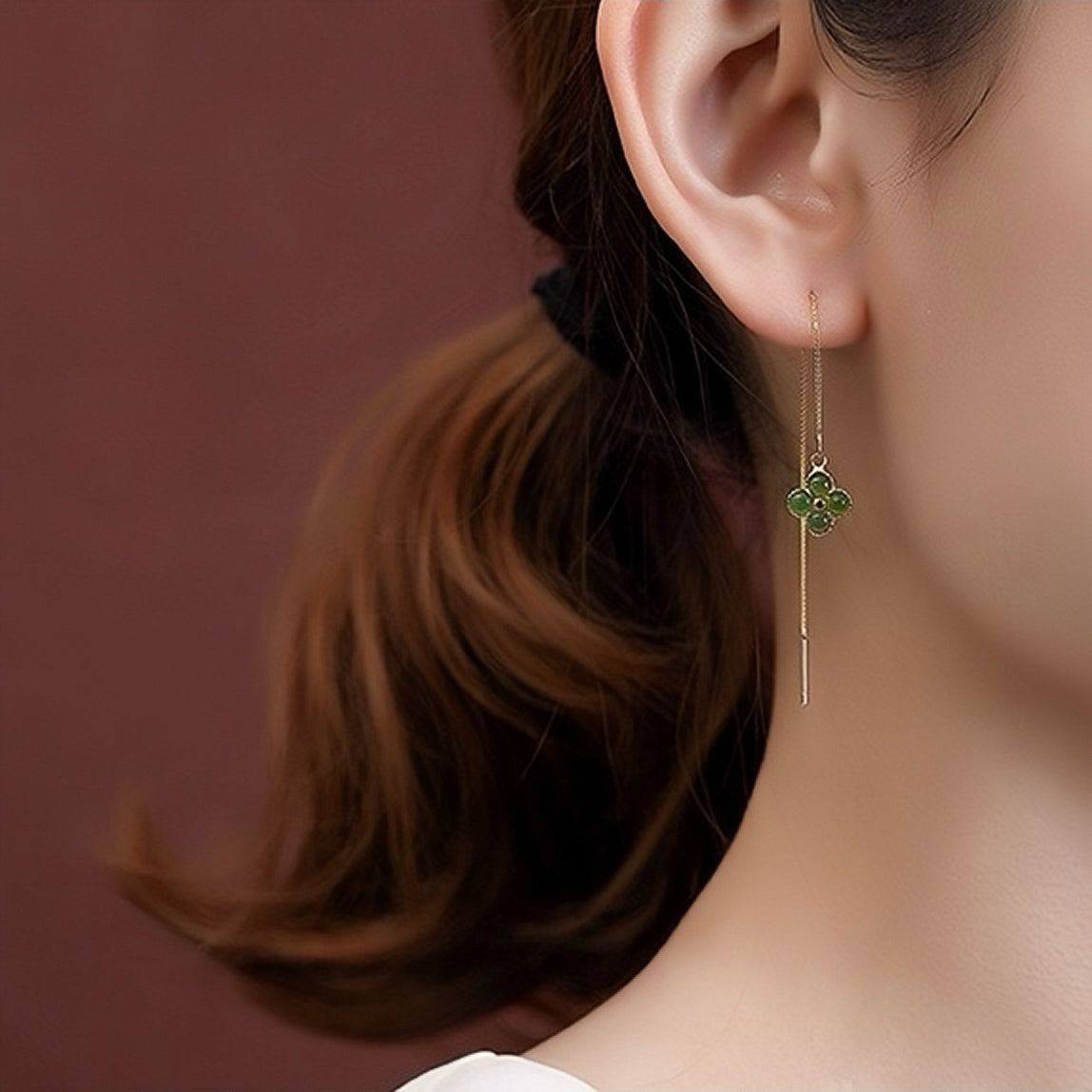 Lucky Streak green jade clover drop earrings on a woman's ear