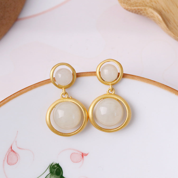 Solstice — Hetian Jade Sun Drop Earrings with gold frames and white jade beads.