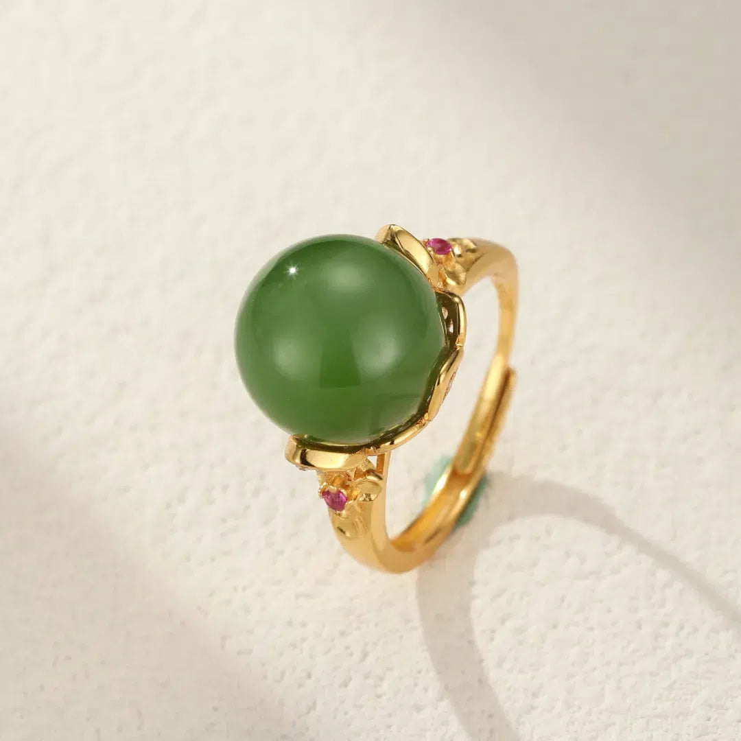 Sovereign green jade solitaire ring with gold plating and small ruby accents
