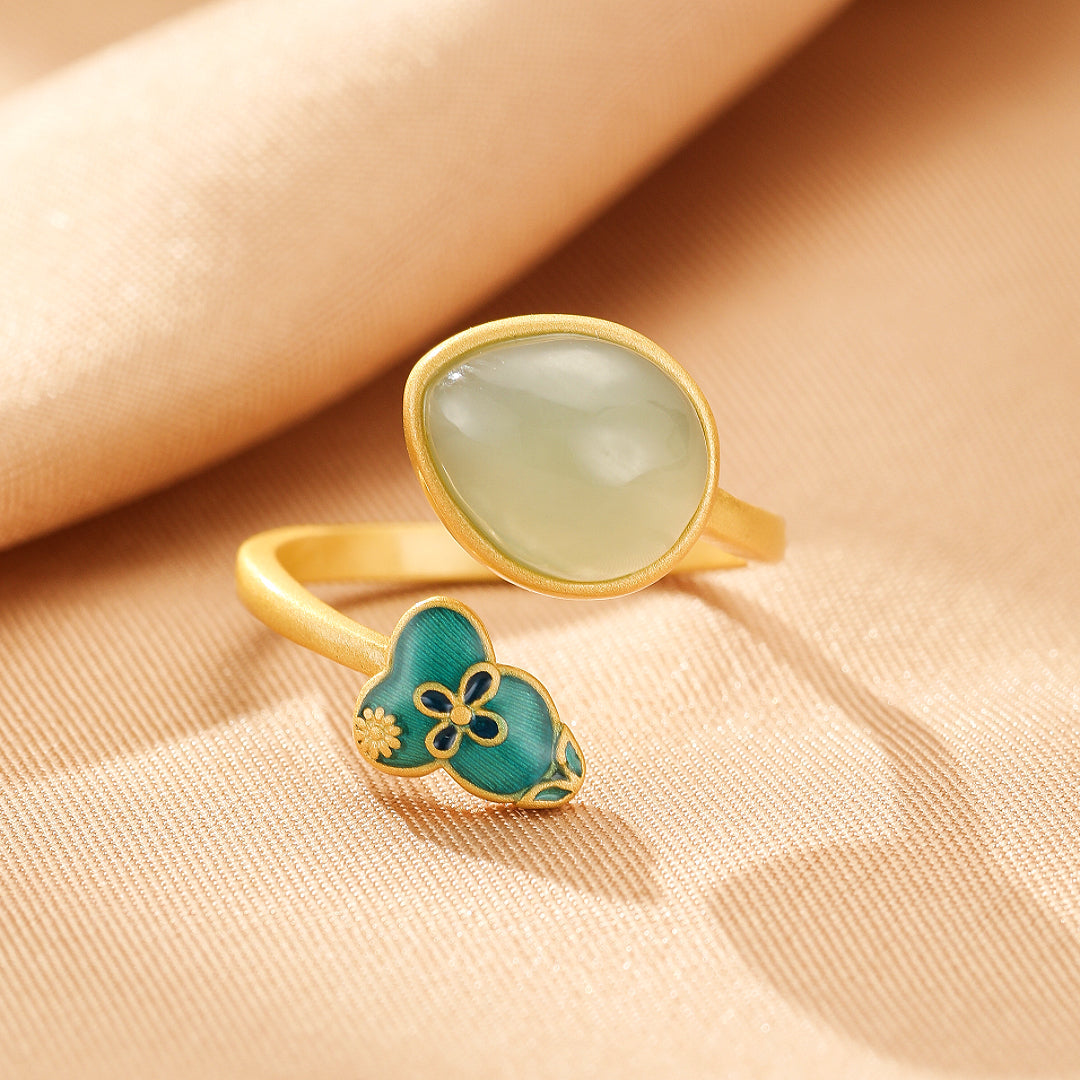 Gold plated silver ring featuring a smooth, oval Hetian jade stone and a decorative gourd shape inlaid with teal enamel and a floral motif.