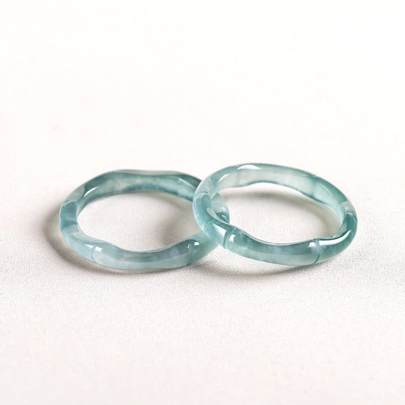 Two translucent blue jade bamboo rings with a smooth, wavy surface, presented on a white background.