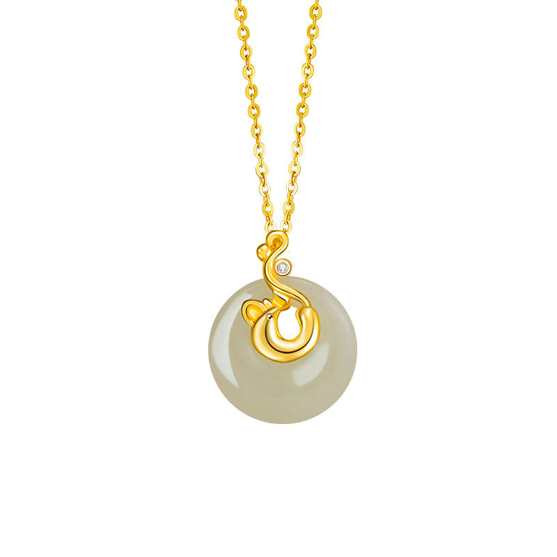 Gold necklace with a round, translucent Hetian jade pendant and a gold swirl design accented with a small diamond.