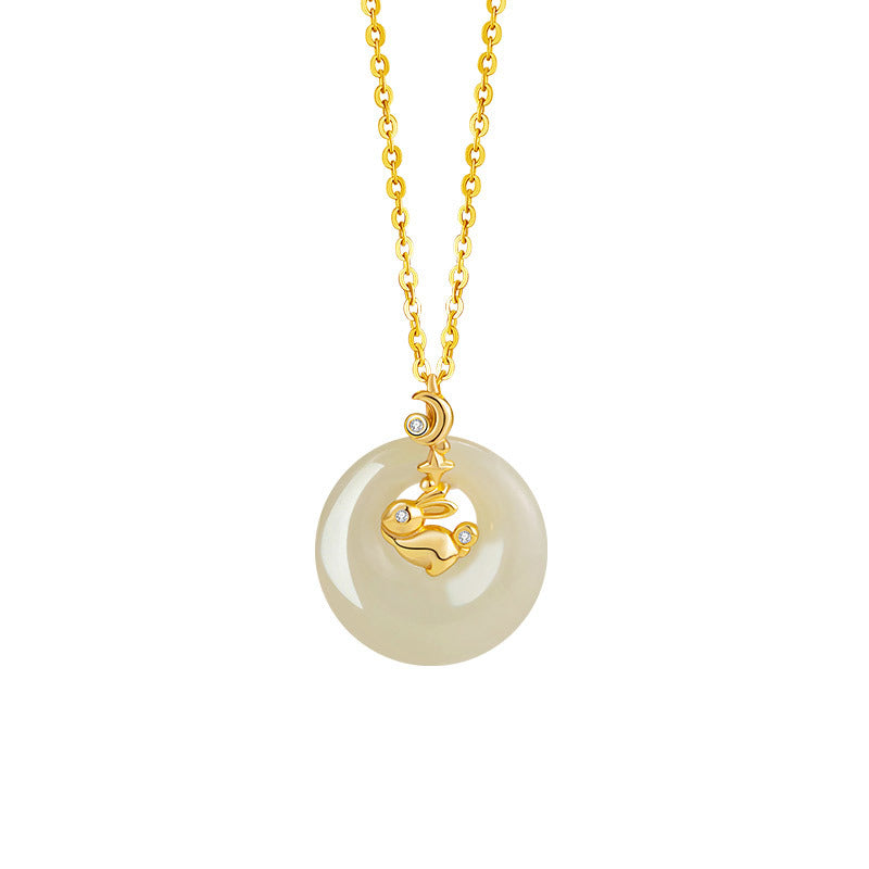 Gold necklace with a light green Hetian jade donut pendant featuring a gold rabbit charm with small diamonds.