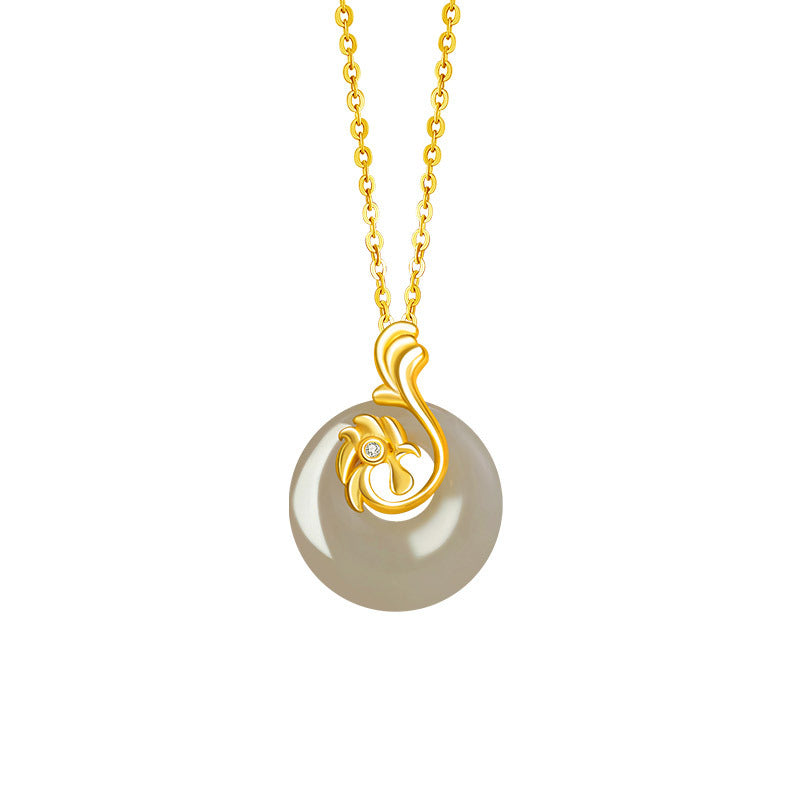 Birthright pendant necklace featuring a round, translucent Hetian jade stone with a golden floral-inspired bail and a small diamond accent.