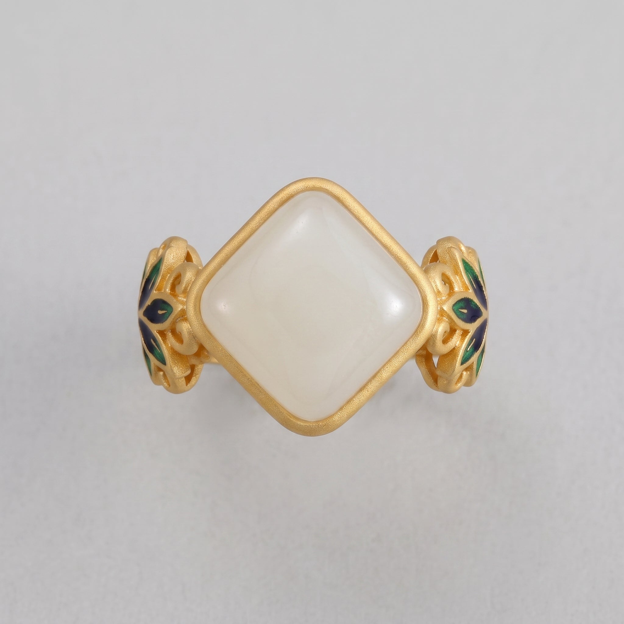 Ease Hetian Jade Lotus Ring with a square white jade gemstone set in a gold band with green and blue enamel floral details.