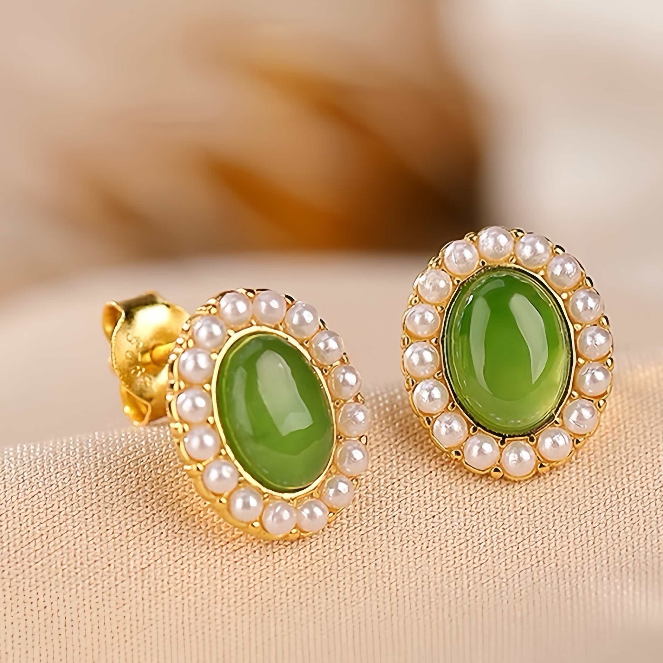 First Light green jade sun stud earrings with a halo of small pearls, set in gold-plated silver.