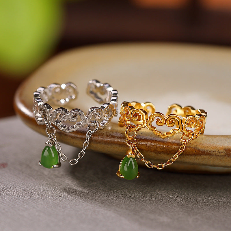 Two adjustable rings, one silver and one gold, featuring cloud designs and dangling green jade teardrop charms.