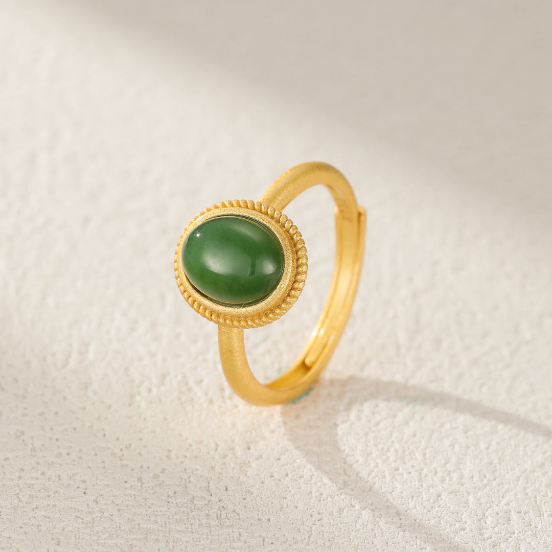 New Day gold plated silver ring with a green jade cabochon stone, featuring a textured bezel setting and a simple band.