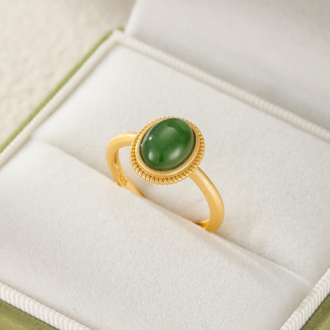 New Day gold plated silver ring featuring a smooth, oval green jade cabochon set in a textured bezel.