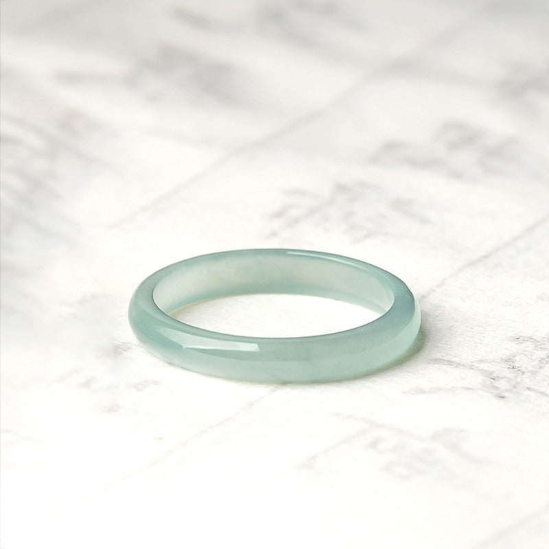 Same Sky - Ice Jade Couple Band Ring, a simple, translucent light green jade band ring on a white marble background.