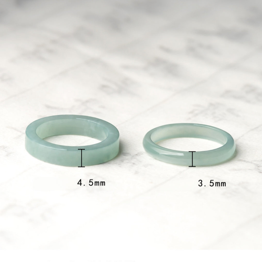 Two matching ice jade band rings, one 4.5mm wide and the other 3.5mm wide, displayed side-by-side on a marbled background.