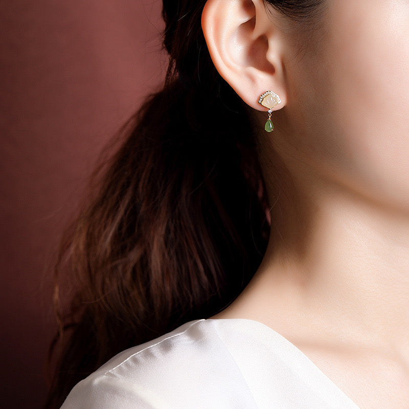 Slow Dance Hetian Jade Water Drop Earrings featuring a fan-shaped mother-of-pearl top and a dangling green jade teardrop.