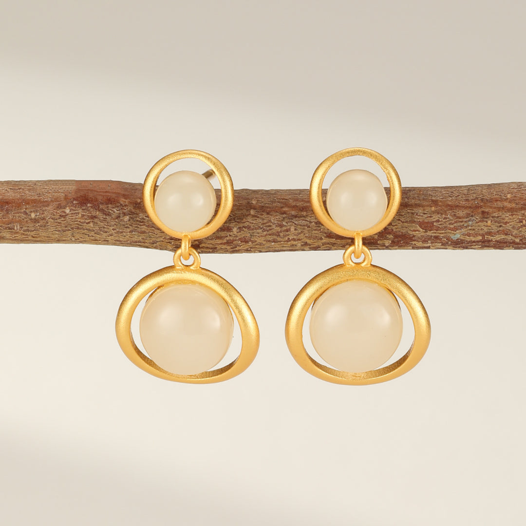 Solstice Hetian Jade Sun Drop Earrings featuring a modern gold-plated silver design with round jade stones.
