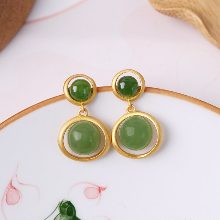 Solstice Hetian Jade Sun Drop Earrings with gold accents and green jade stones