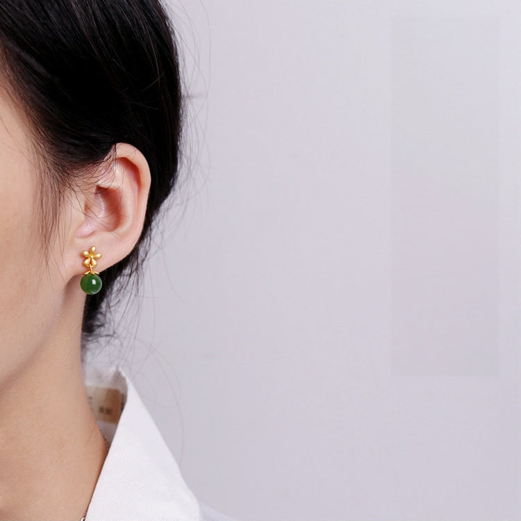 Sweet Nothings Hetian Jade Flower Drop Earrings featuring a gold flower stud with a green jade bead dangling below.