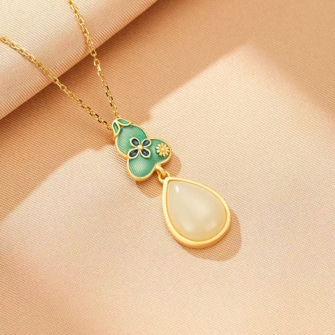 Twice Blessed Hetian Jade Gourd Jewelry Set featuring a gold-plated silver chain and a pendant with green enamel, floral details, and a teardrop-shaped white jade stone.