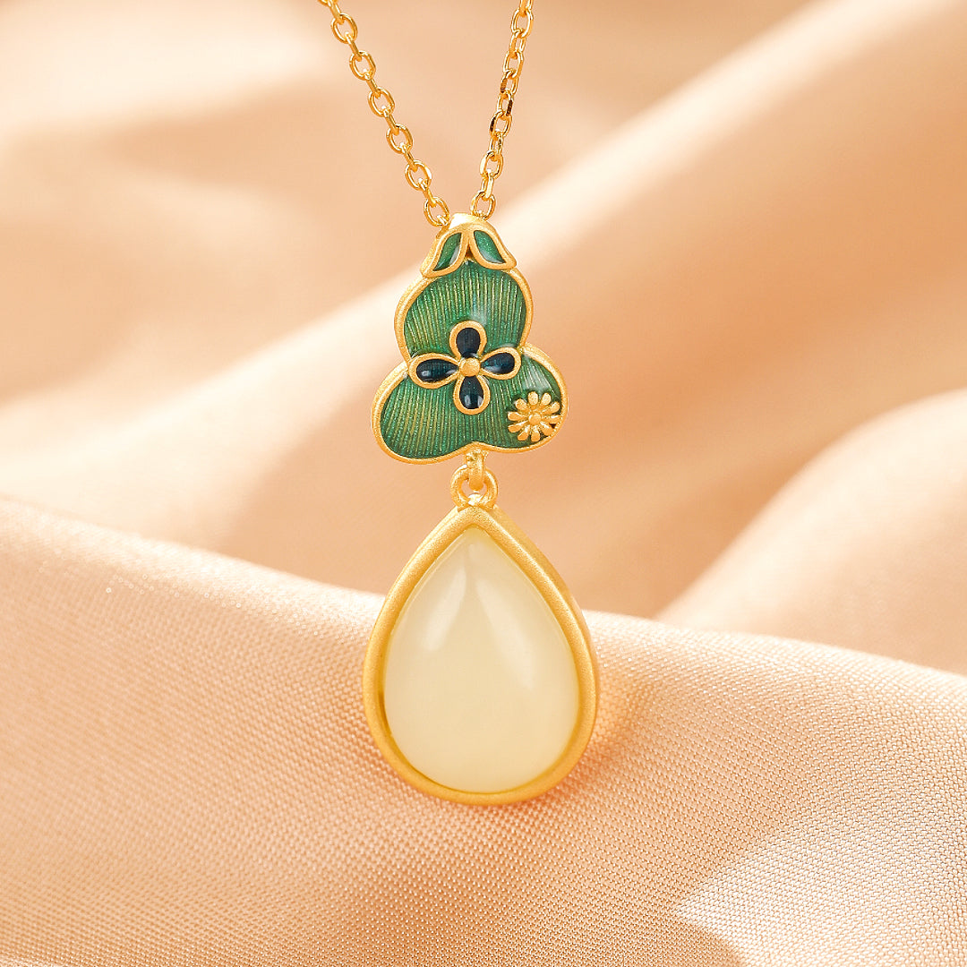 Gold-plated silver necklace with a green enamel gourd pendant featuring floral details and a teardrop-shaped Hetian jade stone.
